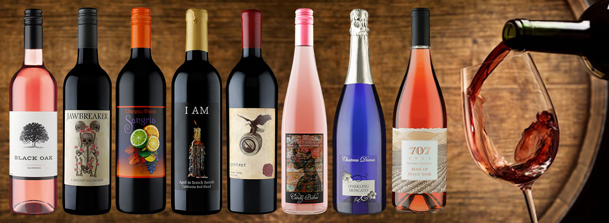 A spread of wines in front of a wooden background.